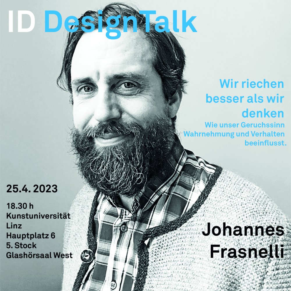 Einladung zum Design Talk mit Johanes Frasnelli - Portrait von Johannes Frasnelli. Ein Mann mit kurzen dunklem Haar und Bart lächelt in die Kamera. Er trägt ein kariertes Hemd und eine Lodenjacke.